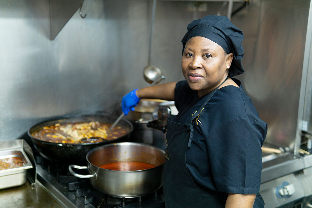 Woman in a coronavirus hospital cooking for hospitalized patients